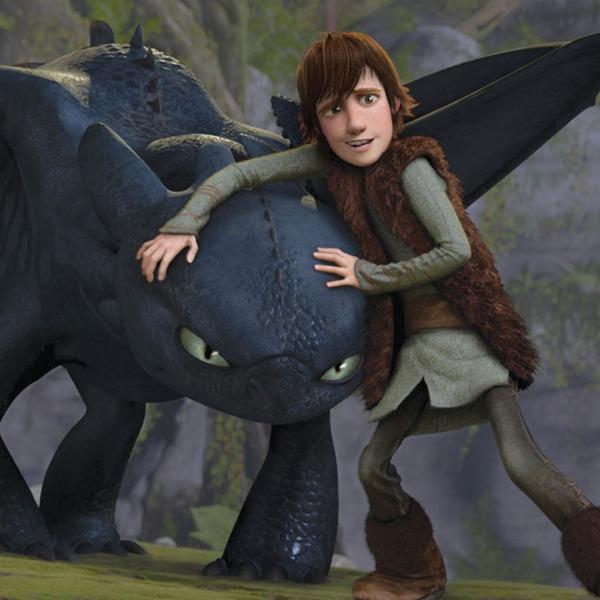 Animated still of a large black dragon with open wings and black scales, its head held by a boy in brown fur in a mountainous setting.