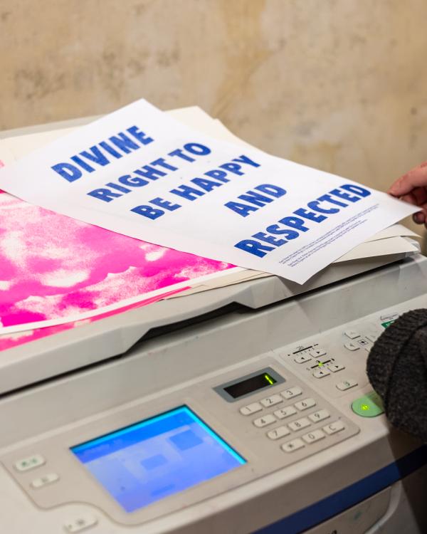 A poster print can be seen on top of a risograph printer