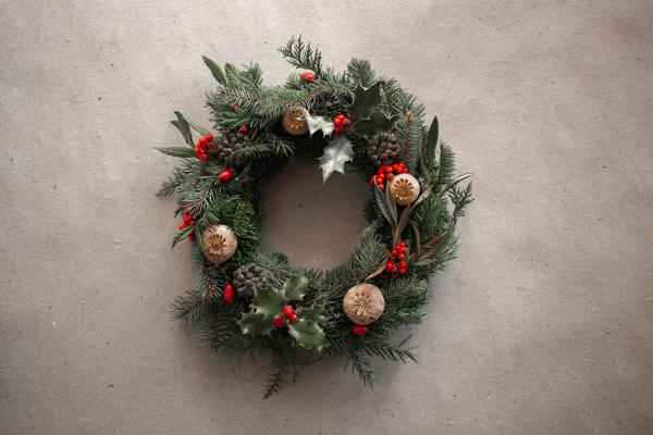 A handmade Christmas wreath with holly leaves and red berries