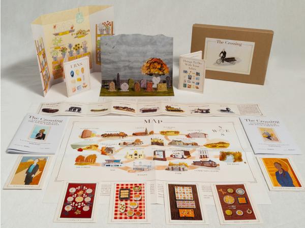 A cardboard box next to a selection of illustrated images, booklets and pop up resources