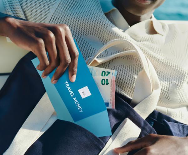 A man puts a travel money wallet into his bag
