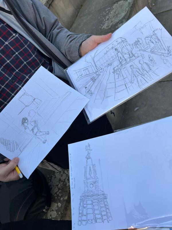 Photos shows three sketches of people and monuments in Leeds city centre.