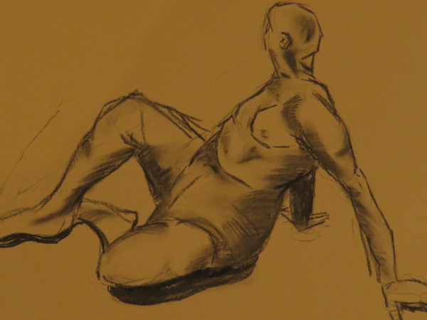 Charcoal life drawing sketch on brown paper.
