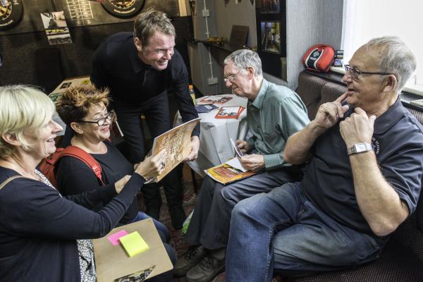 A group of people looking at a book 