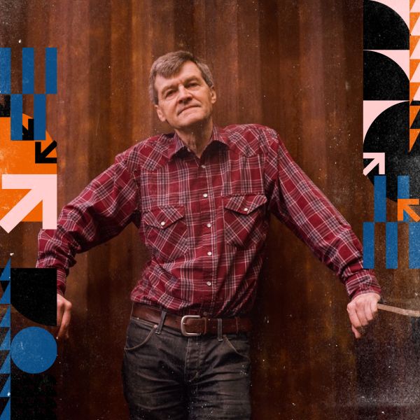 Paul Murphy standing against a wooden background