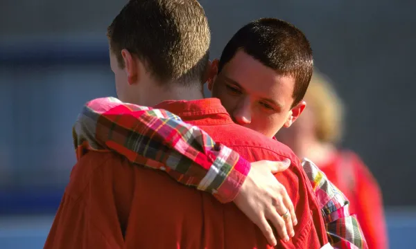 A young boy hugs his precious acolyte.