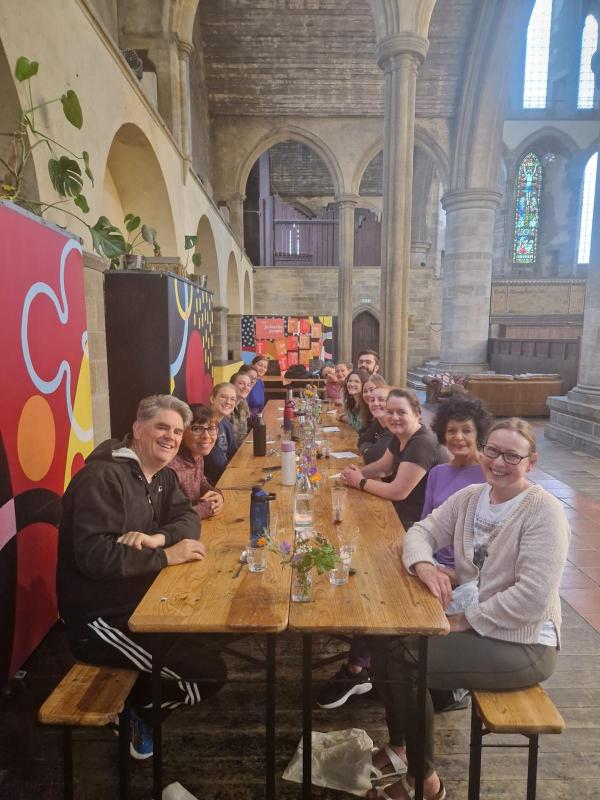 Our Yoga Brunch community sat on a long table enjoying a communal brunch at Left Bank Leeds