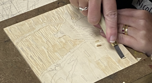 An image of birds being carved into a woodcut block