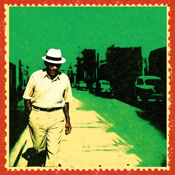 Stylised grainy photo of a man walking down a Cuban street in a white hat and shirt, edited as part of a green and yellow postcard.