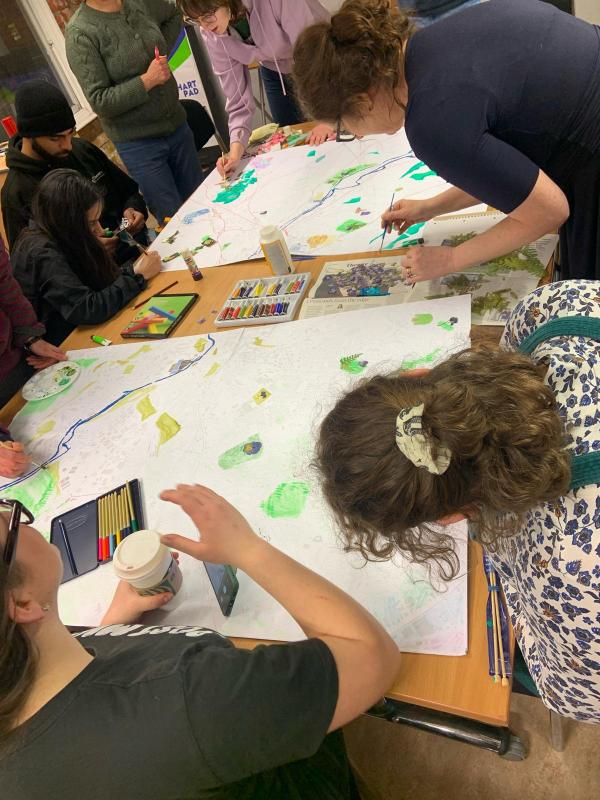 A group of local change-makers work together on creating a map of Leeds, using art materials.