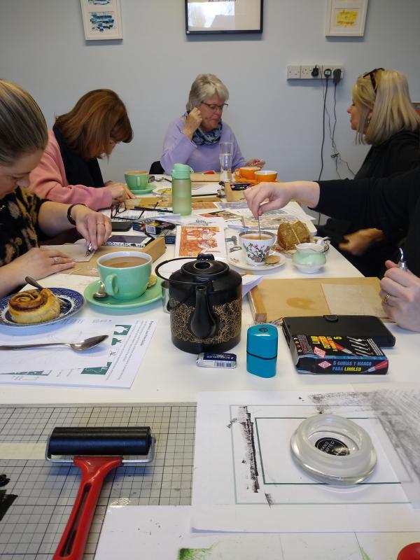 People working with lino print