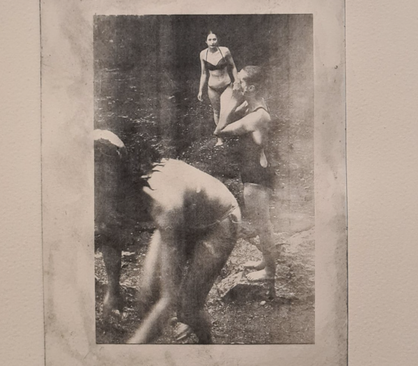 A photogravure print of women bathing in a river