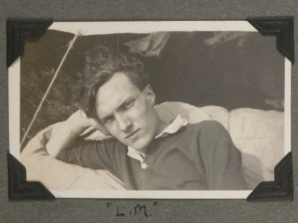 A black and white photo of a man resting his head on one hand.