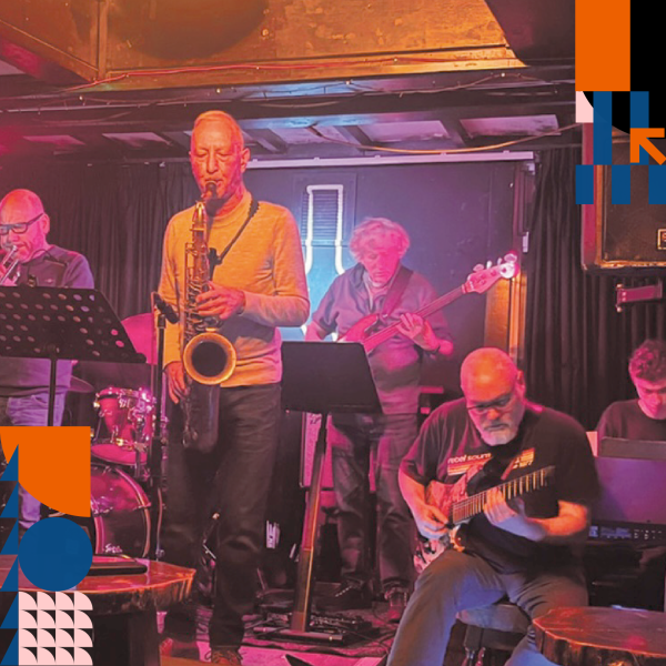 5 musicians playing different instruments on stage.