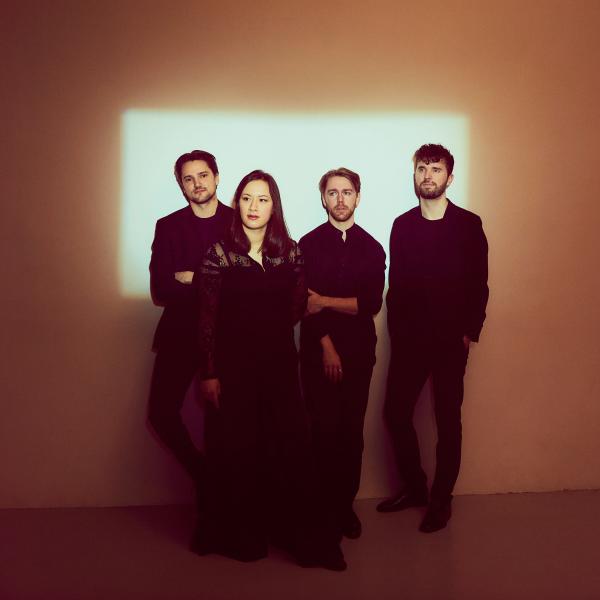 The four members of Opus13 Quartet in black concert dress.