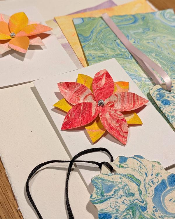 Image shows various marbled papers made into decorations, cards and bookmarks
