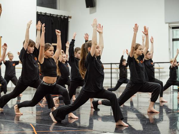 Group of young people taking part in dance class