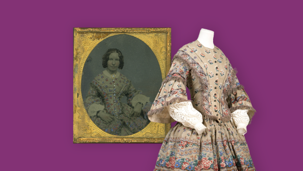 A purple background with a mannequin with a Victorian dress on and a framed photograph of a woman wearing the dress.