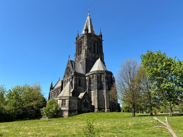 A church set on a hill surrounded by green grass