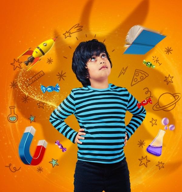 a boy in a striped top with science objects around him
