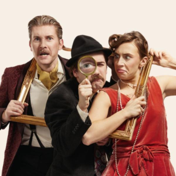 Three characters in glamorous period costume are squeezed together through a golden frame, the central figure holding a magnifying glass and wearing a black hat.