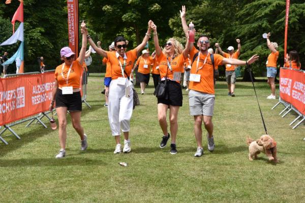 Four participants and their dog taking part and having fun in Walk For A Cure.