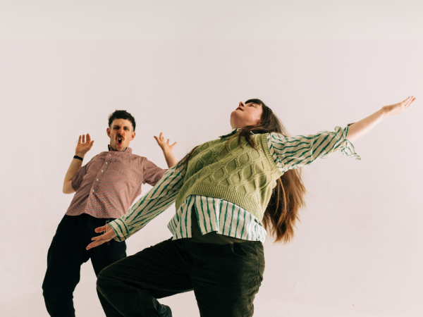 2 people dancing expressively 