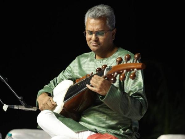 Man holding sarod