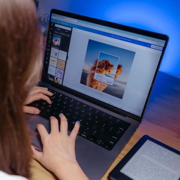 A photograph from over someone's shoulder, showing them using Canva