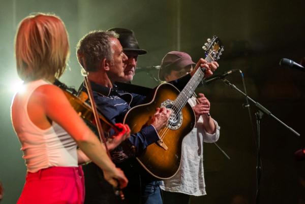 Group of musicians with guitar, fiddle and whistle