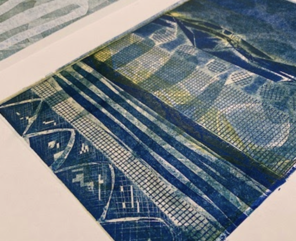 An abstract collograph print in shades of blue and yellow