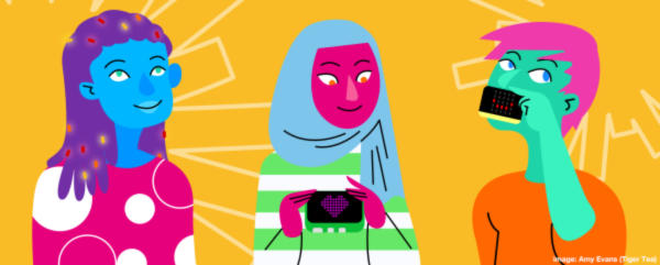 Three people holding coding devices