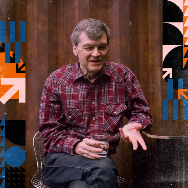 Paul Murphy sitting down with a glass on a wooden background