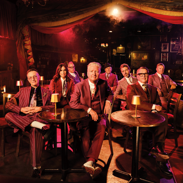 Squeeze band sat down together in a club.