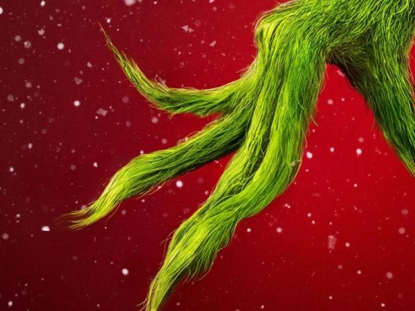 The Grinch's hand on a red background with snowflakes 