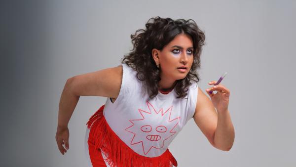 A woman poses as if she's about to start a race.