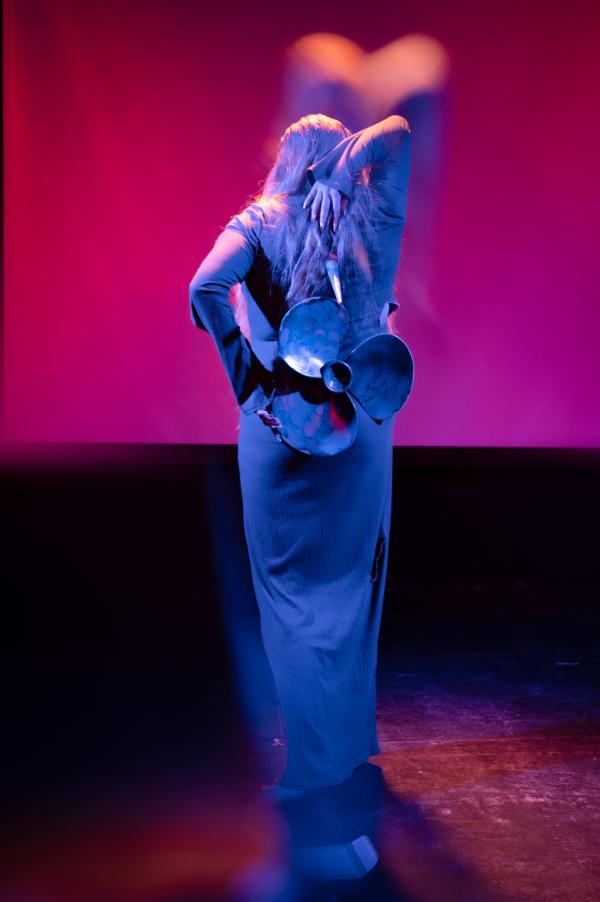 A lady in a dress wears a small propeller on her back