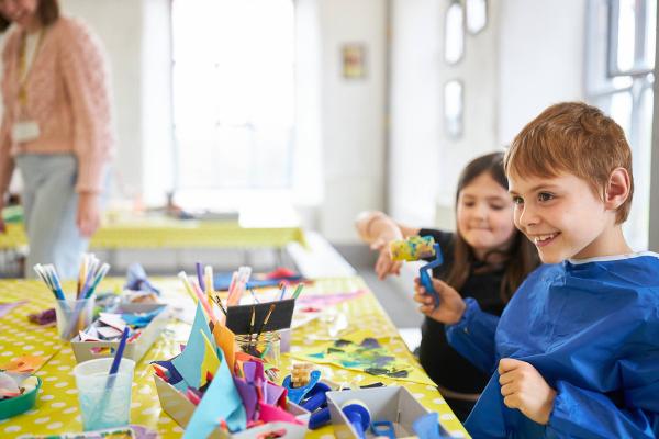 An image of a child with printing materials