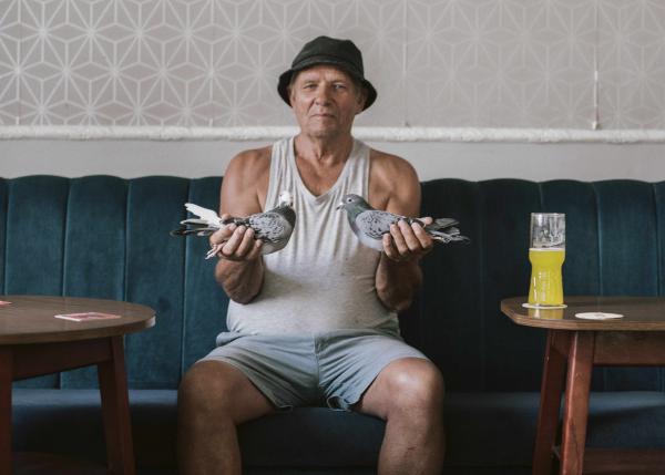 Man holding two pigeons