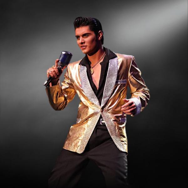 Emilio Santoro performs as Elvis into a microphone, wearing a gold jacket and black shirt with open neckline.