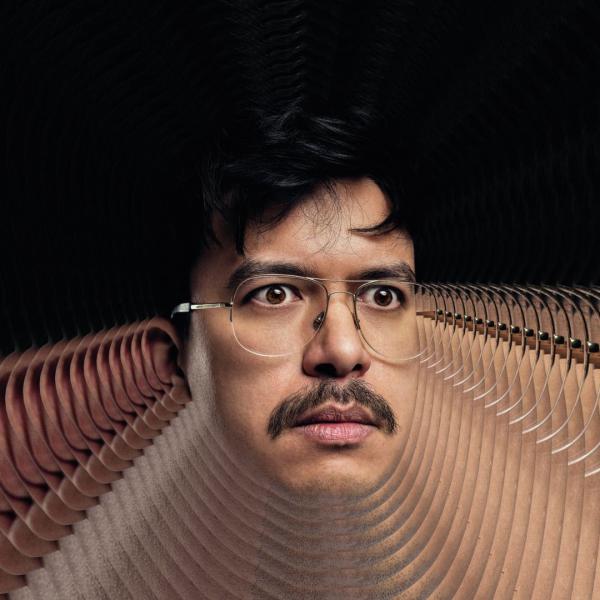 Photograph of Phil Wang's face surrounded by copies of itself, to give a trippy effect.