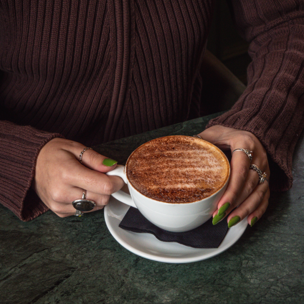 Hands holding a coffee.