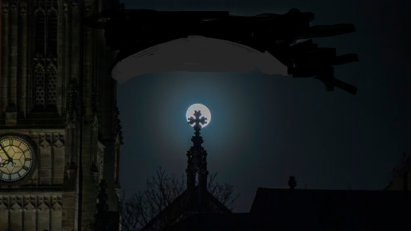 Dark and gloomy picture of the night sky with the faint outside of a church