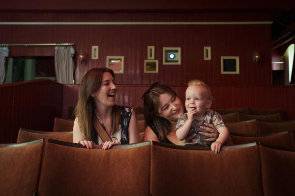 A family sat in a row of cinema seats