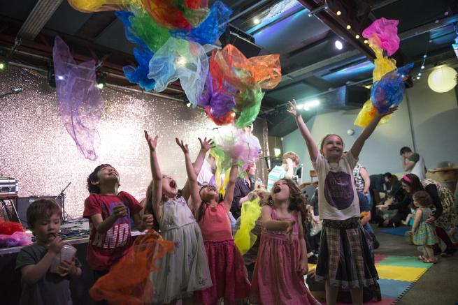 Children throwing scarves in the air.