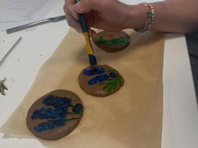 Someone crafting an art project with paint