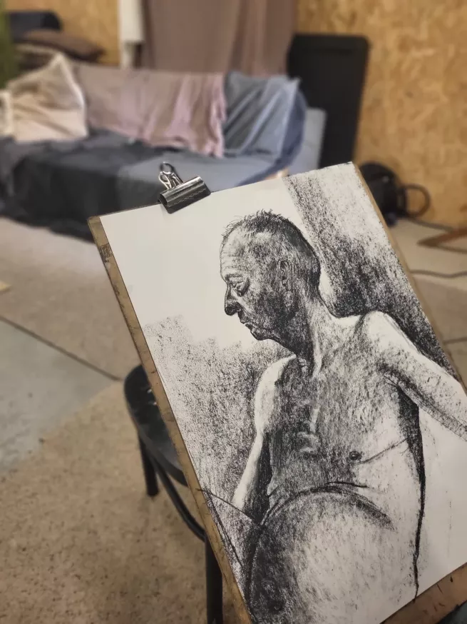 A charcoal drawing of a male life model