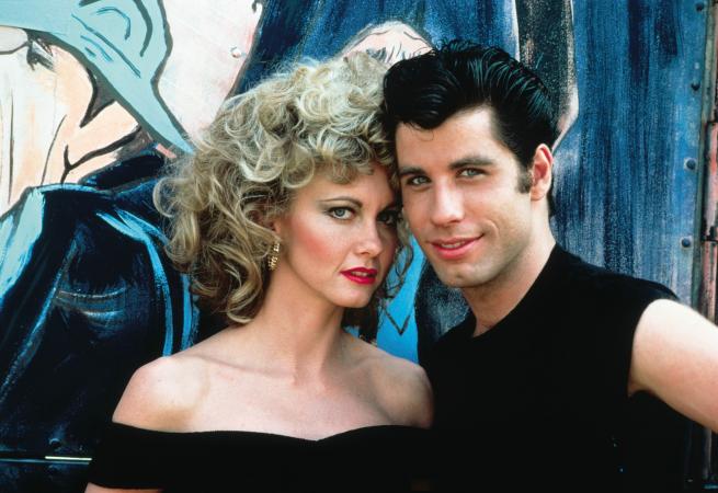 A promotional photograph for Grease featuring Sandy Olsson and Danny Zuko played by Olivia Newton-John and John Travolta respectively.