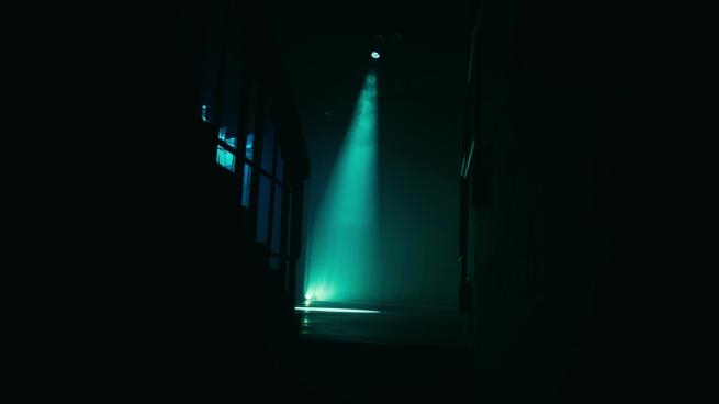 A spotlight on a dark stage