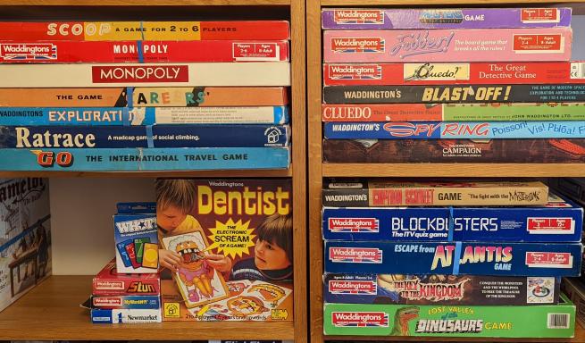 A shelf showing an array of vintage Waddingtons games. 